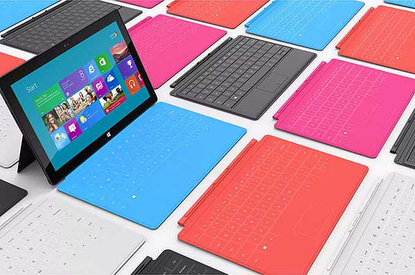 A Microsoft Surface PC surrounded by TouchCover and TypeCover keyboards of different colors
