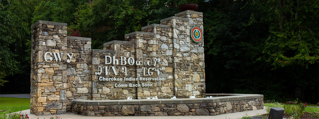 A stonework welcome sign for the Eastern Band of Cherokee Indians’ reservation in Cherokee, North Carolina. The sign is written using both the Cherokee syllabary as well as the English translation which reads ‘Cherokee Indian Reservation / Come Back Soon.’