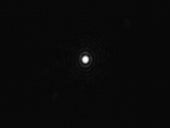 Detail from an image of a white dot on a black background shot through a camera directly