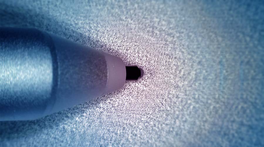 A stylus tip against a patterned substrate