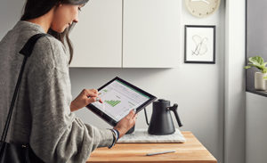 Image of a worker at home using a tablet.
