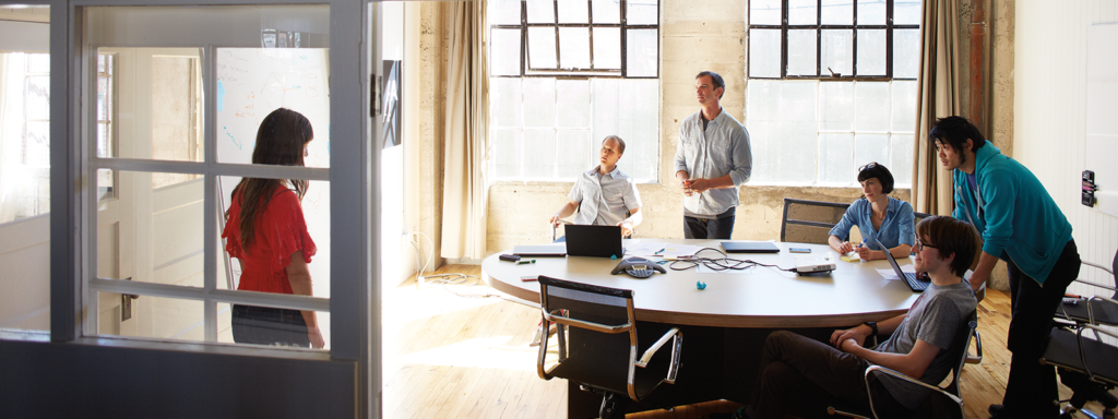 Image of four coworkers collaborating in an office.