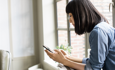 A woman works from her mobile phone.