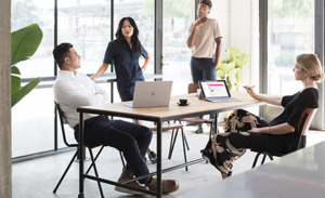 Image of a team of four firstline workers collaborating around a table.