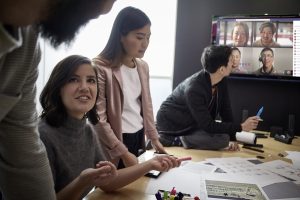 Female/Male small business professionals collaborating using Microsoft Teams.