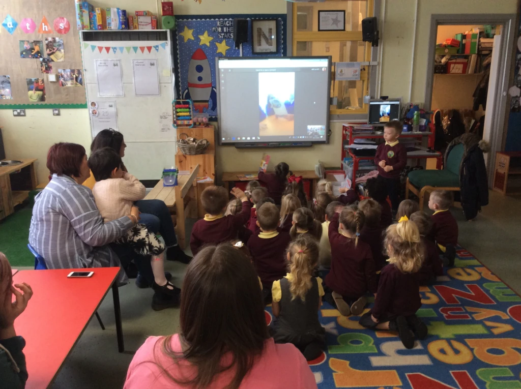 Darran Park Primary School students get a lesson over Skype. A classroom of students sit in front of a screen.