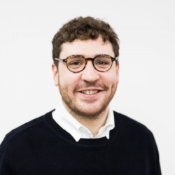 Photo of smiling man with dark hair and glasses, Ramsey Marwan