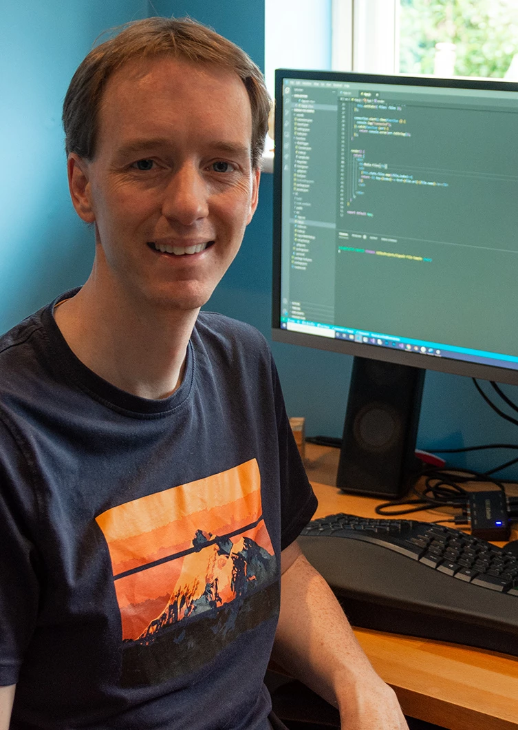 a person sitting at a desk in front of a computer