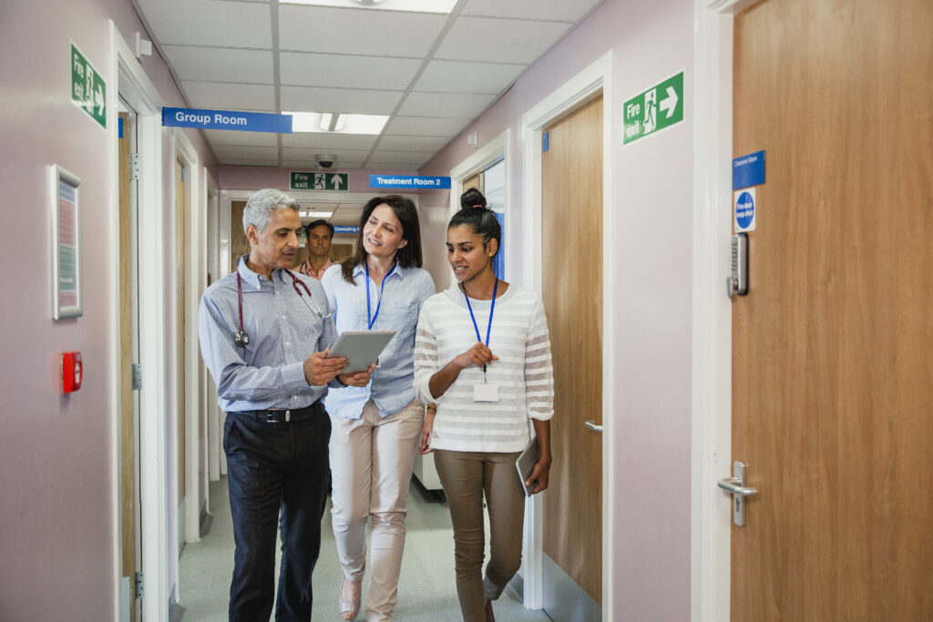 Three Doctors Walking Down the Corridor