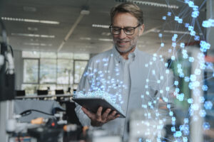 Smiling engineer looks at a digital tablet