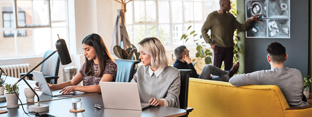 Image of a group of Firstline Workers working together in an open space work environment.