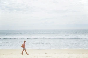 a person standing on top of a sandy beach