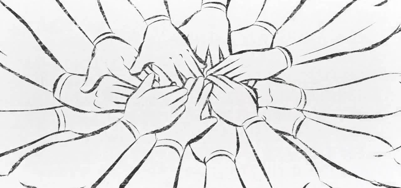 Hands stacked on top of each other in a huddle.