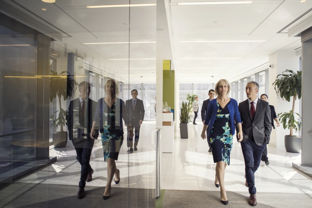 A group of people walking on in the office.