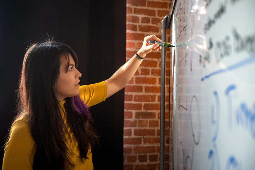 Female writing on whiteboard