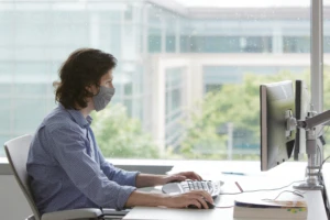 Photo of a man sitting at a table in front of a window