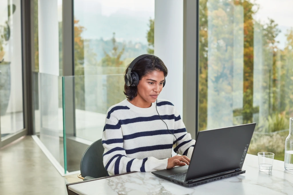 College student looking at laptop on a table