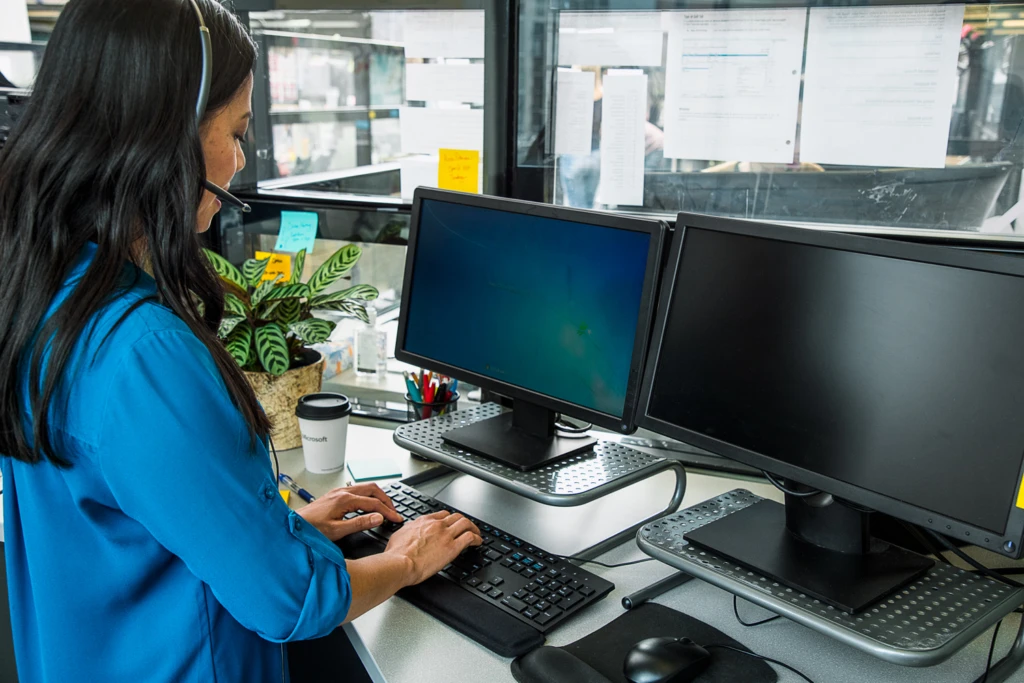 a person sitting at a desk in front of a computer