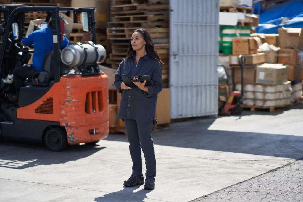 Woman with tablet in factory