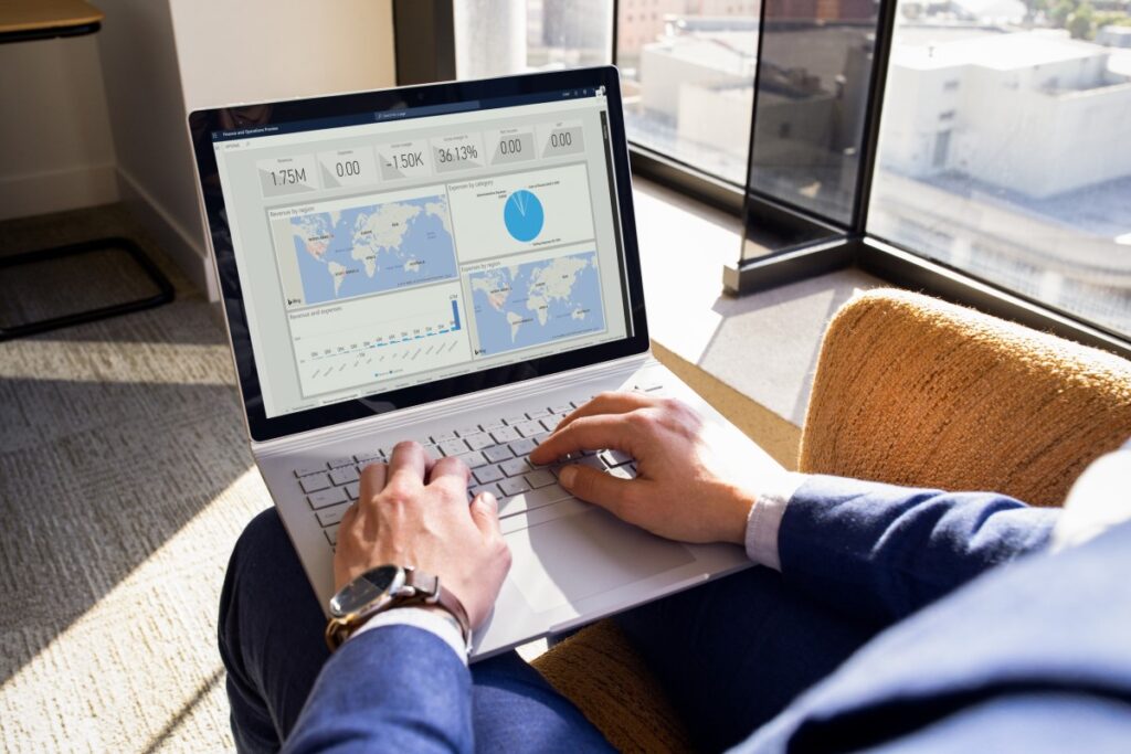 a person sitting at a table using a laptop