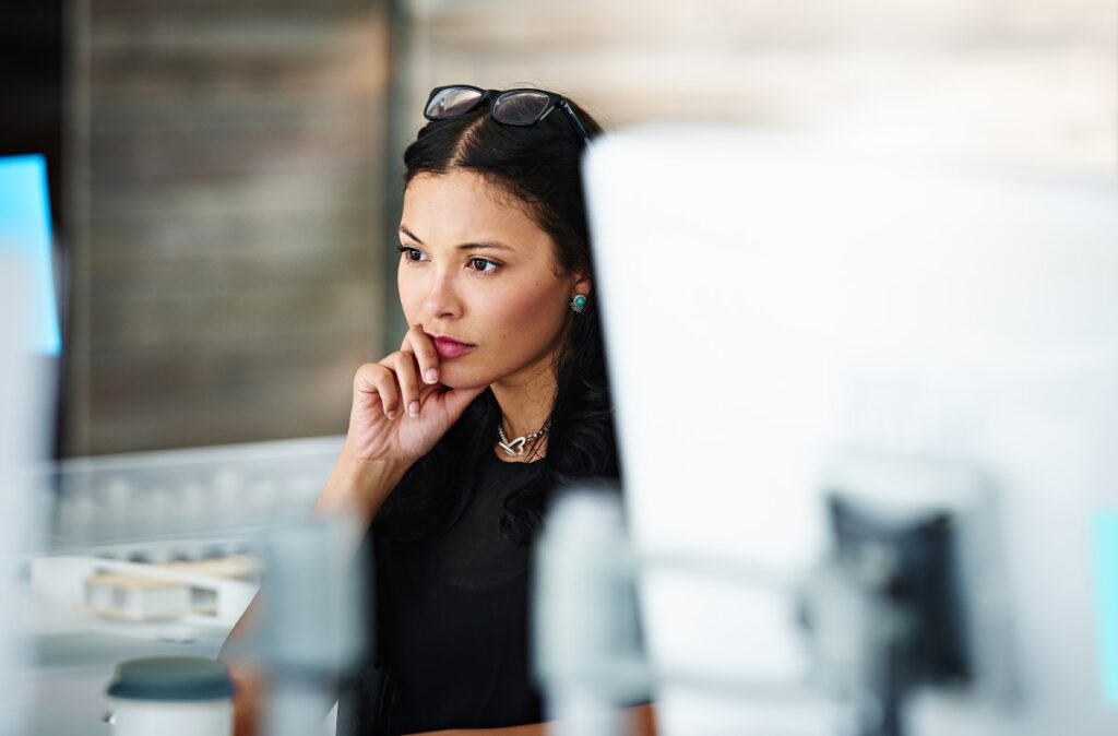 Woman concentrating at a workstation.