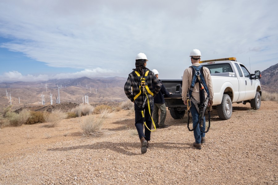 a man riding a bike down a dirt road