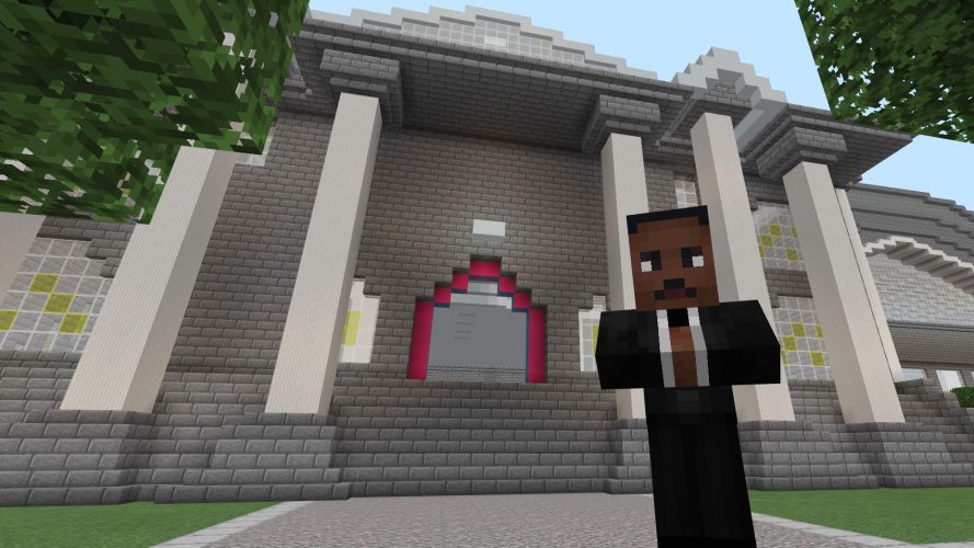 Martin Luther King Jr. stands in front of a columned museum entrance.