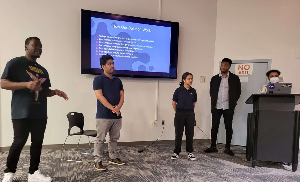 Crew members present their solution to mission control at the hackathon closing ceremony. From left: Demario Asquitt, Hridweek Karki, Anu Uphadhya, Mubarek Abdela, Getaante Yilma