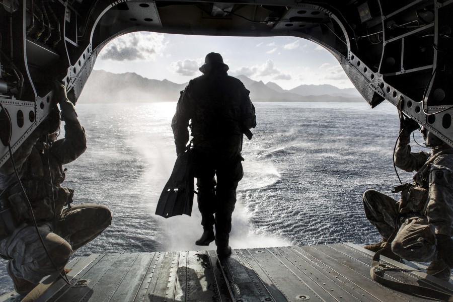 Military diver exiting rear of aircraft.