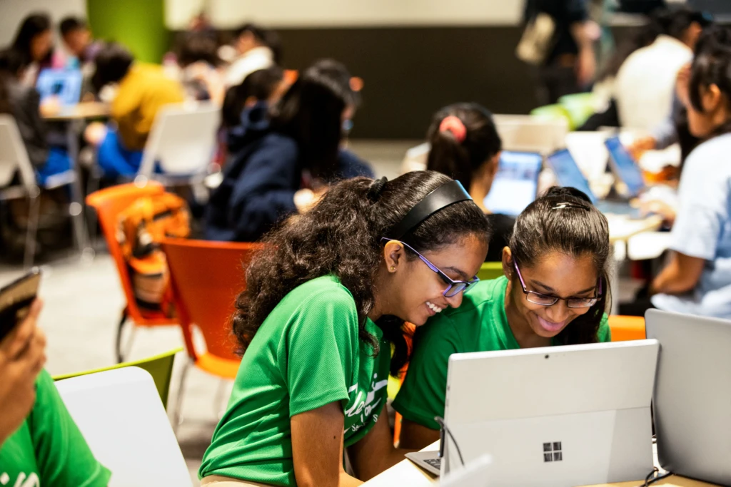 Two friends work on a computer together during Microsoft‘s DigiGirlz event in Singapore. The DigiGirlz program gives middle and high school girls opportunities to learn about careers in technology, connect with Microsoft employees, and participate in hands-on computer and technology workshops.