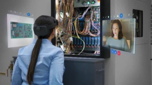 Woman using Remote Assist hologram during a wiring project.