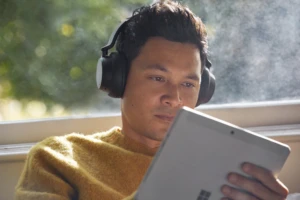 Photograph of male inside wearing Surface Headphones 2 while working on Surface Go2. Data-driven strategies can help improve online experiences for shoppers.