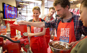 Image of a worker scooping chocolate at Tony's Chocolonely.
