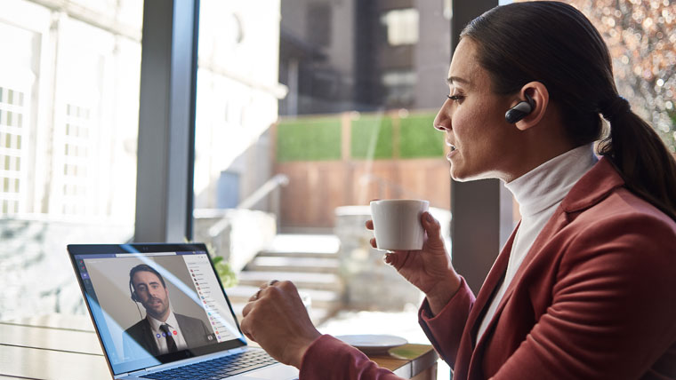 Female small business executive using HP Elite device running Microsoft Teams conference call.