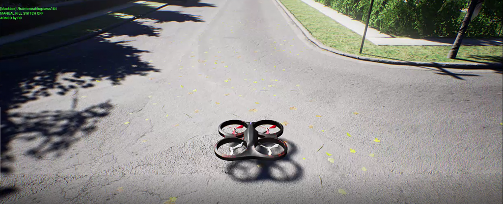 AirSim drone hovering just above the street