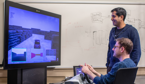 a man standing in front of a computer screen