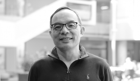 Xuedong Huang wearing glasses and smiling at the camera