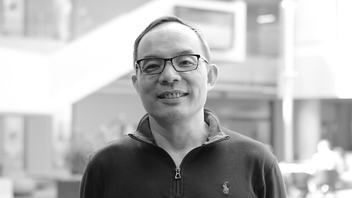 Xuedong Huang wearing glasses and smiling at the camera
