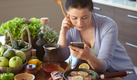 a woman sitting at a table with a plate of food