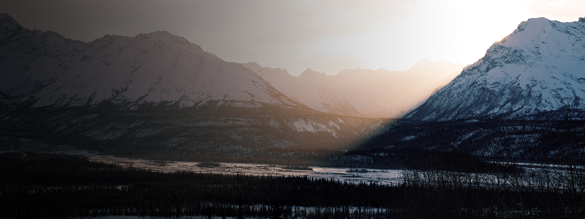 sun setting over mountain ranges in Anchorage, Alaska