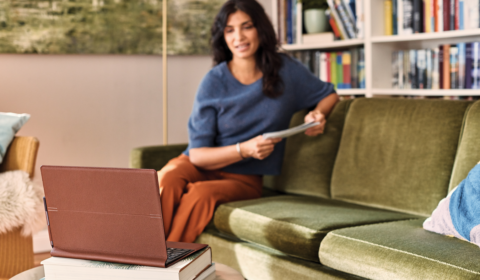 a woman sitting at a table using a laptop