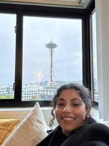 a person sitting in front of a window posing for the camera