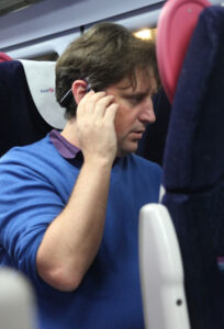 Soundscape - Man on a train using Soundscape with a bone conduction headset