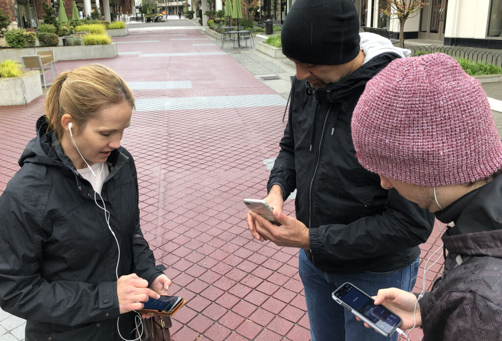 Three members of the Soundscape team testing Soundscape in an outdoor shopping area