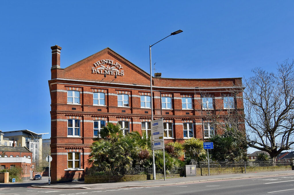 a large red-brick building with a sign reading ‘Huntley and Palmers’