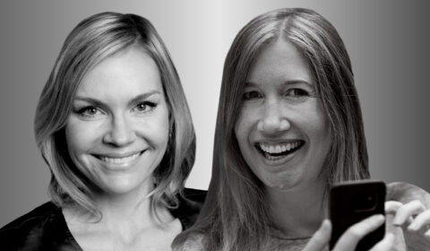 Portraits of Microsoft researchers Ginger Hudson and Jaime Teevan photographed in black and white. Both smile and look forward. Teevan, on the right, is holding a cell phone in the lower right of the frame.