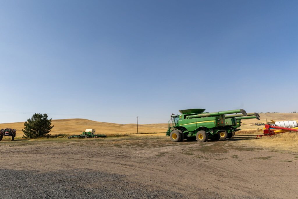 a truck is parked on the side of a dirt road