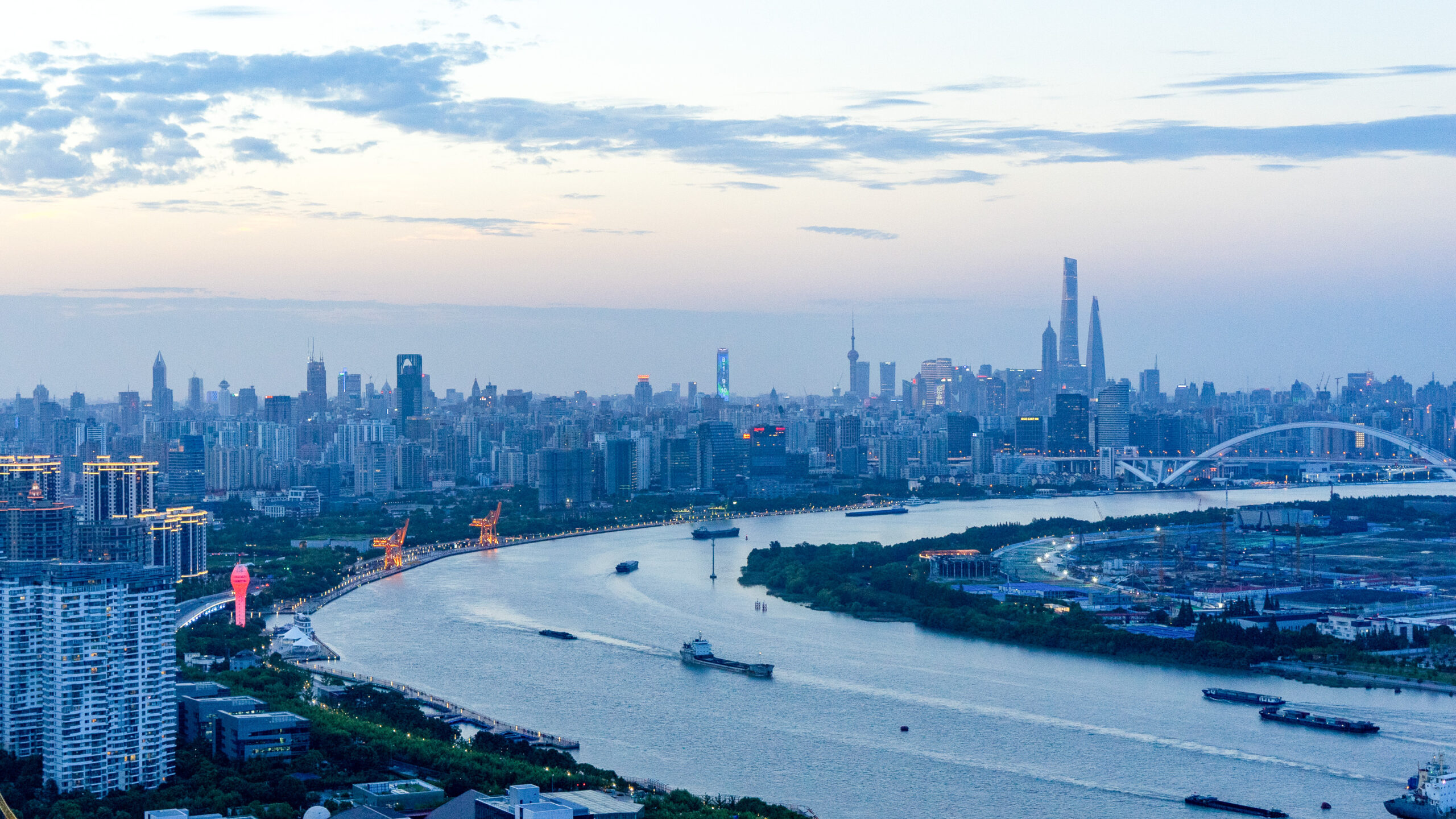 a large body of water with a city in the background