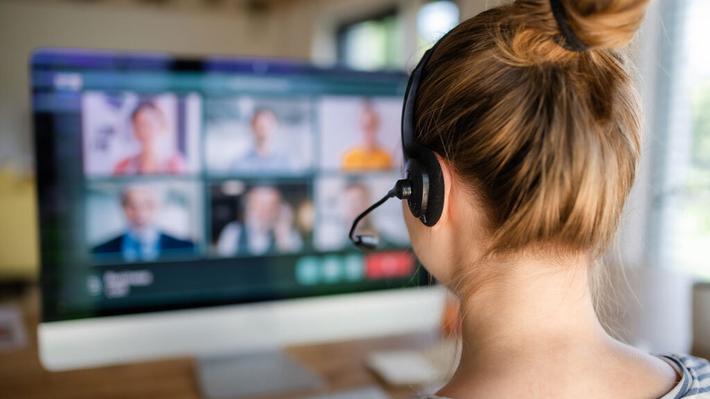 woman wearing a headset on a virtual video meeting