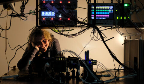 Francesca Parmigiani framed by wires lights and modulators